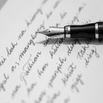 Black and white photo of a fountain pen on a handwritten letter, capturing classic writing elegance.